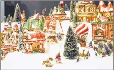  ?? ADAM MACINNIS/THE NEWS ?? Visitors to the Museum of Industry have a chance to see Tiny Tinsel Town, a display that includes more than 200 houses, 3,000 trees and 1,000 figures. It will be on display until Dec. 21.