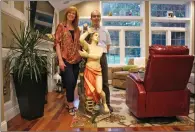  ?? EMMA LEE/WHYY VIA AP ?? In this June 14 photo provided by WHYY, Ed and Kathleen Nader stand in their living room in Exton, Pa, with a statue of St. Pantaleon that has been in Ed's family for four generation­s. The nearly lifesized statue missing for decades from an Italian...