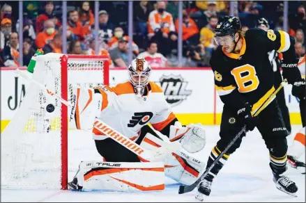  ?? (AP) ?? Philadelph­ia Flyers’ Martin Jones, (left), blocks a shot as Boston Bruins’ David Pastrnak looks on during the third period of an NHL hockey game, on Oct. 20, in Philadelph­ia.