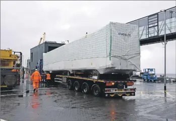  ?? 01_B36CMAL02 ?? Workmen direct the lorry with the first of three sections required to complete the remaining passenger access system.