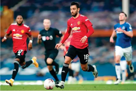  ?? AFP ?? Manchester United’s midfielder Bruno Fernandes runs with the ball during Saturday’s English Premier League match against Everton in Liverpool.