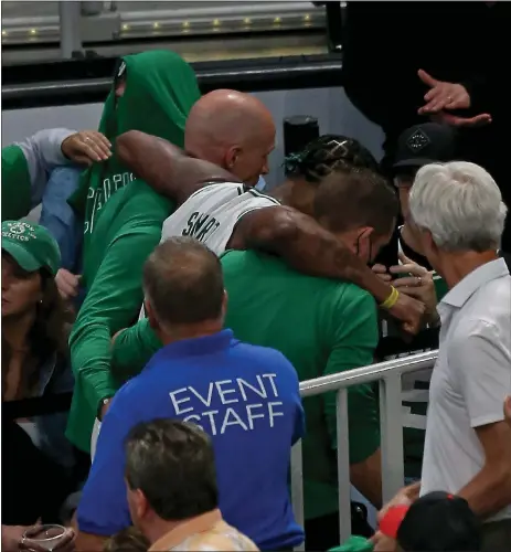  ?? STUART CAHILL / BOSTON HERALD ?? Marcus Smart is carried off the court to the locker room before returning during Game 3 of the Eastern Conference Finals in the Celtics’ 109-103 loss.