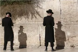  ??  ?? HAREDI MEN pray yesterday at the Western Wall in Jerusalem.