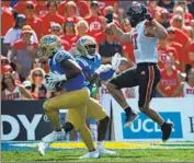  ?? Luis Sinco Los Angeles Times ?? DARIUS MUASAU intercepts a pass intended for Thomas Yassmin to end an early Utah drive.