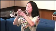  ?? PHOTO COURTESY OF TROY SCHOOLS AND THE HOM FAMILY ?? Isabella Hom plays the bugle at the national inaugurati­on of the first class of female Eagle Scouts.