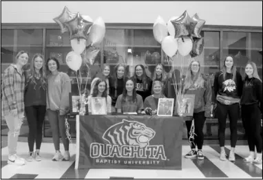  ?? Photo by Gerren Smith ?? Kodee Batchelor with members of the Poyen Lady Indians softball team during signing day at the Jerry and Ouida Newton Arena Thursday.