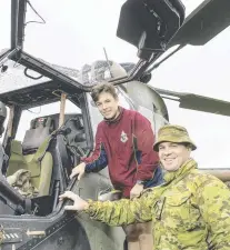  ?? Picture: Nev Madsen ?? CLOSE LOOK: Flying instructor Captain Cameron Wilson shows navy cadet Andrew Gill around the ARH Tiger helicopter.