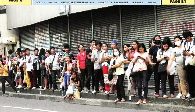  ?? BING GONZALES ?? PASSENGERS bound for Barangay Catalunan Grande line up while waiting for jeepneys along C. Bangoy Street on Wednesday afternoon. The city government will soon deploy 25 buses to serve Catalunan Grande area and 10 buses in Diversion Road as part of the implementa­tion of Davao Interim Bus System.