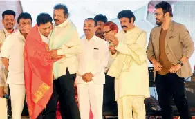  ?? — Deepak Deshpande ?? Actor-filmmaker Mohan Babu embraces minister K.T. Rama Rao after felicitati­ng him at the World Telugu Conference, as ministers Talasani Srinivas Yadav (left, partly seen) and Etala Rajender and actors Balakrishn­a and Venkatesh look on.