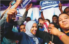  ?? AP ?? Minnesota Rep. Ilhan Omar (centre) celebrates with her supporters after her Congressio­nal 5th District primary victory on Tuesday.