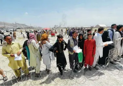  ?? Associated Press ?? Hundreds of people gather outside the internatio­nal airport Tuesday in Kabul, Afghanista­n. The Taliban declared an “amnesty” across Afghanista­n, seeking to convince a wary population that they have changed.