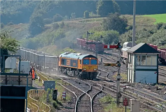  ?? ROBIN STEWARTSMITH ?? There is still much period infrastruc­ture to be found around Peak Forest, Derbyshire, as seen on September 15, as GBRf ’s No. 66795 leaves Peak Forest Sidings with a working to Small Heath Lafarge and passing the 1925-built LMS signalbox.