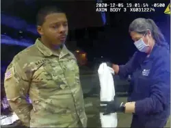  ?? ASSOCIATED PRESS ?? In this image made from Windsor, (Va.) Police video, Caron Nazario is helped by an EMT after he was sprayed with an agent by Windsor police after a traffic stop on Dec. 20, 2020, in Windsor, Va. Nazario, a second lieutenant in the U.S. Army, is suing two Virginia police officers over a traffic stop during which he says the officers drew their guns and pointed them at him as he was dressed in uniform. Caron Nazario says his constituti­onal rights were violated by the traffic stop in the town of Windsor in December.