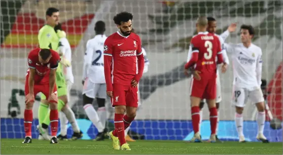  ??  ?? Mohamed Salah cuts a dejected figure after Real Madrid dumped Liverpool out of the Champions League at Anfield last night