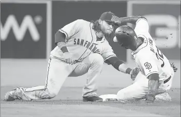  ?? DENIS POROY — GETTY IMAGES ?? The Padres’ Jabari Blash is tagged out by the Giants’ Brandon Crawford in an attempted steal of second base in the fourth inning. The Giants lost the game and failed to win a series against San Diego for the eighth straight time.