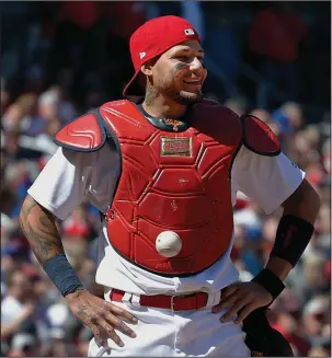  ?? The Associated Press ?? STUCK ON YOU: St. Louis catcher Yadier Molina stands with his hands on his hips and a ball somehow stuck to his chest protector during the seventh inning of the Cardinals’ home game Thursday against the Chicago Cubs. The ball stuck to Molina’s chest...