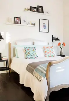  ??  ?? MAIN BEDROOM Above An Antoinette bedframe from Loaf takes centre stage, framed by Frosini wall lamps from Made and Bekvam footstools, used as bedside tables, from Ikea. Kahrs engineered oak flooring from The Floor Store brings a rustic touch, while cushions from We Love Cushions dress the bed