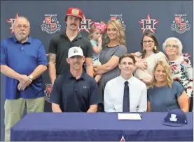  ?? Scott Herpst ?? A number of family members joined friends, teammates and coaches to watch Heritage senior Cade Kiniry sign a letter of intent to join the baseball program at Truett-McConnell University this past Wednesday.