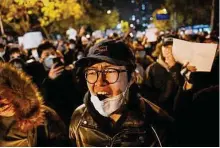  ?? Noel Celis / Tribune News Service ?? Protesters rally for the victims of a deadly fire as well as against China’s harsh COVID-19 restrictio­ns in Beijing.