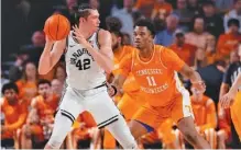  ?? TENNESSEE ATHLETICS PHOTO ?? Tennessee freshman forward Tobe Awaka, shown guarding Vanderbilt’s Quintin Millora-Brown during Wednesday night’s 66-65 loss in Nashville, played a season-high 22 minutes against the Commodores and tallied eight points and nine rebounds.