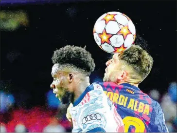  ?? AFP ?? Bayern’s Canadian midfielder Alphonso Davies vies for the ball with Barca’s Spanish defender Jordi Alba (right) during the UCL first round group E football match on Tuesday.