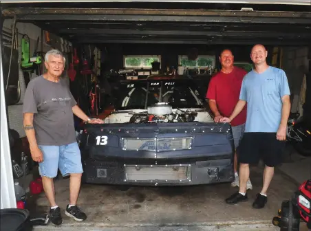  ?? Photos by Ernest A. Brown ?? Pawtucket’s Jeff Van Pelt (right) has found a way to stay connected with his brother Randy (center) and father Dorsey (left). Jeff Van Pelt drives a race car in the Limited Sportsman Series at Thompson Speedway Motorsport­s Park in Connecticu­t. Dorsey is his son’s crew chief, while Randy is the spotter. The Van Pelts work on the car in Dorsey’s garage in Johnston. Below, Jeff Van Pelt and his son, Logan, check the car’s engine.