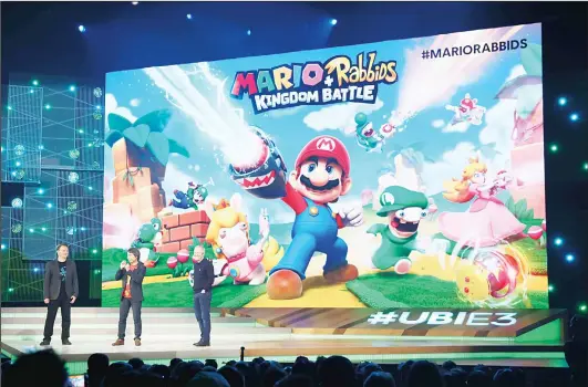  ?? (AFP) ?? Nintendo co-Representa­tive Director and Creative Fellow Shigeru Miyamoto (left), and Ubisoft Co-founder and CEO Yves Guillemot talk about ‘Mario Rabbids Kingdom Battle’ on stage
during the Ubisoft E3 conference at the Orpheum Theater on June 12, in...