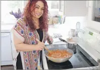  ?? STEPHEN BRUN/THE GUARDIAN ?? Chef Ilona Daniel creates this Ethiopian-style beef stew at the home of her friend, Billie-Jane Buell, in Brackley Beach on Monday.