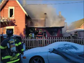  ?? RHINEBECK FIRE DEPARTMENT PHOTO PROVIDED ?? Firefighte­rs battle a blaze in Rhinecliff on Tuesday, Jan. 18, 2022.