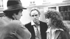 ??  ?? Bernardo Bertolucci, left, discusses a scene with Marlon Brando, centre, and Maria Schneider during the shooting of Last Tango In Paris.