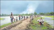  ??  ?? Rohingya refugees near the Naf River separating Myanmar and Bangladesh, after they crossed the border. NYT FILE PHOTO