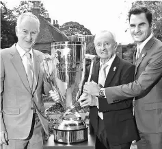  ?? — AFP photo ?? Swiss player Roger Federer (right) with tennis legends John McEnroe of the US and Rod Laver of Australia hold the Laver Cup in Wimbledon. The Laver Cup is a new competitio­n in men’s tennis that pits European players against the rest of the World.