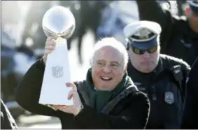  ?? JULIO CORTEZ - THE ASSOCIATED PRESS ?? Philadelph­ia Eagles owner Jeffrey Lurie carries the Vince Lombardi Trophy while walking to a fence to show it to fans gathered to welcome them in Philadelph­ia a day after defeating the New England Patriots in Super Bowl 52, Monday, Feb. 5, 2018.