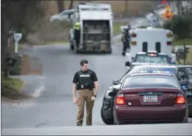  ?? SEAN RAYFORD — THE ASSOCIATED PRESS ?? A police officer approaches a vehicle Thursday at a roadblock near an entrance to the neighborho­od in Cayce, S.C., where 6-year-old Faye Marie Swetlik went missing.