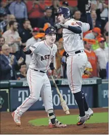  ?? David J. Phillip Associated Press ?? GEORGE SPRINGER, right, and Alex Bregman have been two of the Astros’ hottest hitters in the postseason.