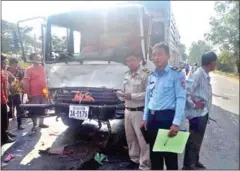  ?? SUPPLIED ?? Officials inspect the scene of a five-truck pileup that injured more than 70 garment workers in Preah Sihanouk province yesterday.
