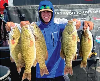  ?? PROVIDED PHOTOS ?? ABOVE: Zach Wolfe displays his third-place catch last year on Lake St. Clair. He is laughing because his dad, Jeff (hidden), is helping him hold the five smallmouth bass. LEFT: Zach Wolfe with his most memorable fish, a 6.34-pound smallmouth bass.