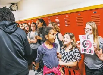  ?? Andrew Rush/Post-Gazette ?? Fourth graders Lizzie Whittier, Jordynn Perrine and Makayla Mckinnis seem more than a little excited to see Malik Hooker Tuesday at George Washington Intermedia­te school in New Castle.