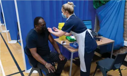  ??  ?? A health worker gives a Covid vaccine to a man in Barry, south Wales. Photograph: Matthew Horwood/Getty Images