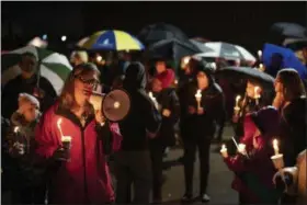  ?? JEFF WHEELER — STAR TRIBUNE VIA AP ?? Sherri Jasper, a Girl Scout board member and counselor at Halmstad Elementary School, leads the program for a candleligh­t vigil at the school in Chippewa Falls, Wis., Sunday.