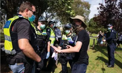  ??  ?? A protester is questioned during a freedom protest in Melbourne, held in response to the government’s Covid-19 restrictio­ns. Photograph: Speed Media/REX/Shuttersto­ck