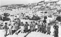  ?? THE ASSOCIATED PRESS FILE PHOTO ?? Jewish fighters, victorious after entering the biblical town of Nazareth in July 1948. Dunkelman refused an order to expel the town’s Arab population.