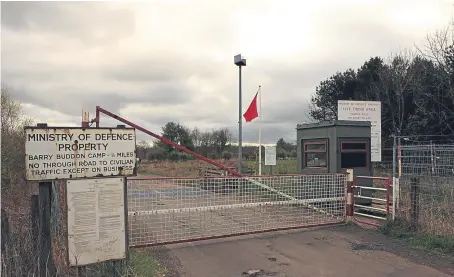  ??  ?? The red flag warning of live firing flies at the main gate to Barry Buddon.