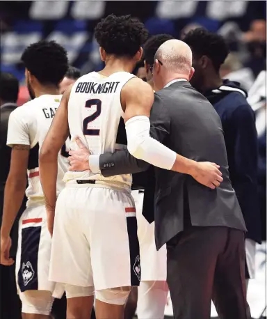  ?? Jessica Hill / Associated Press ?? UConn’s James Bouknight and coach Dan Hurley embrace in the first half during a game in 2020 in Hartford.