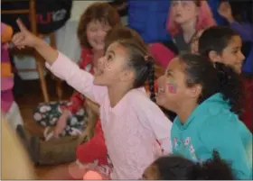  ?? PHOTOS BY MARIAN DENNIS — DIGITAL FIRST MEDIA ?? Kids were all smiles Dec. 15 as they watched a magic show during the 35th annual holiday party for children at Sunnybrook Ballroom.