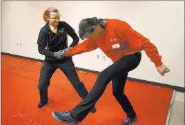  ?? Erik Verduzco ?? Las Vegas Review-journal @Erik_verduzco UNLV police Sgt. Denise Lutey, left, and officer Eileen Wells conduct a demonstrat­ion Wednesday during a Girls on Guard self-defense training class for women at UNLV police headquarte­rs.