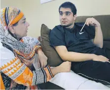 ?? DAN JANISSE ?? Shabana Shahab sits with her autistic son Abdullah Yar Khan, 16, at their Windsor home on Tuesday.