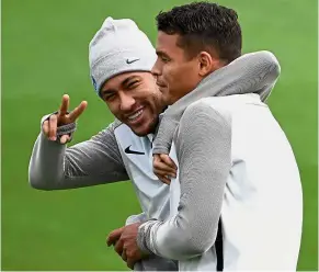  ?? — AFP ?? In jovial mood: Forward Neymar flashing a victory sign on his arrival for Paris St Germain’s training session yesterday with fellow Brazilian Thiago Silva. PSG face Celtic in the Champions League today.