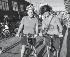  ??  ?? Anne Lucke of Madison (left) and Nancy Schuh of New Berlin turn out for the Bike Fed’s second Polish Moon Ride on Milwaukee’s south side.