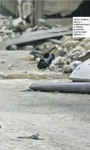  ?? AFP ?? Syrian children play in a neighbourh­ood in Aleppo previously held by rebel fighters